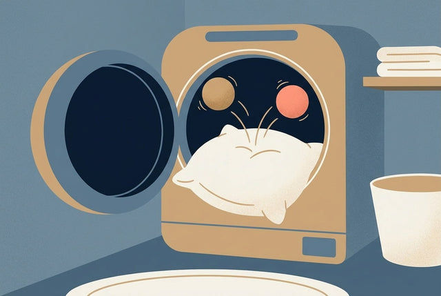 Illustration of a pillow tumbling in a dryer with two dryer balls